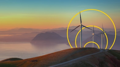 Foto di tre turbine eoliche su una collina con il contorno dell’immagine grafica Obiettivo emissioni nette zero