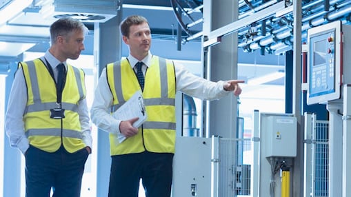 Two engineers walking around the factory