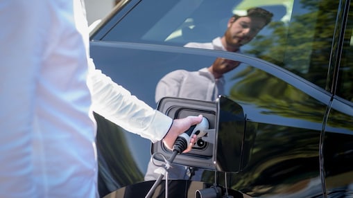Man charging electric car