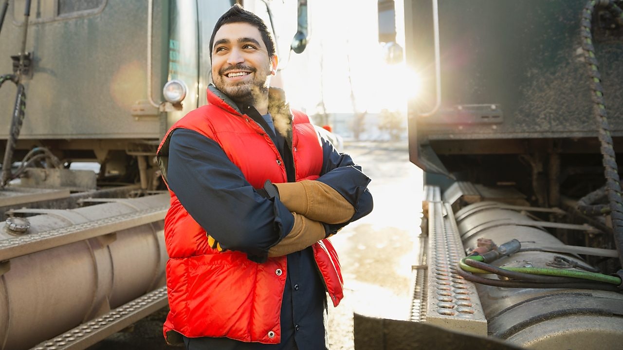 Worker standing by trucks