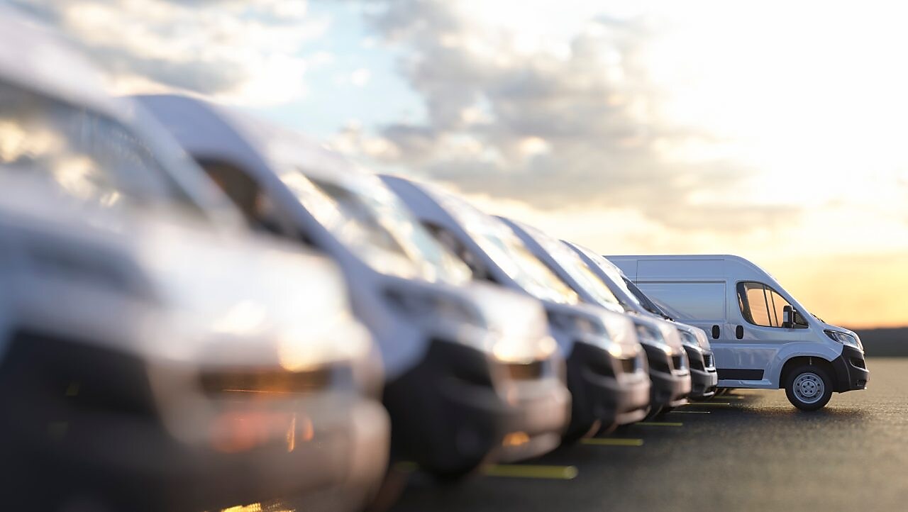Stock photo row of new vans in a parking bay 
