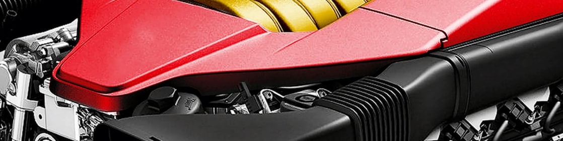 The engine of a car, with red trim and gold middle