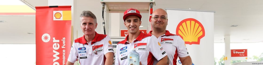 Ducati superbike with seated rider and tech team