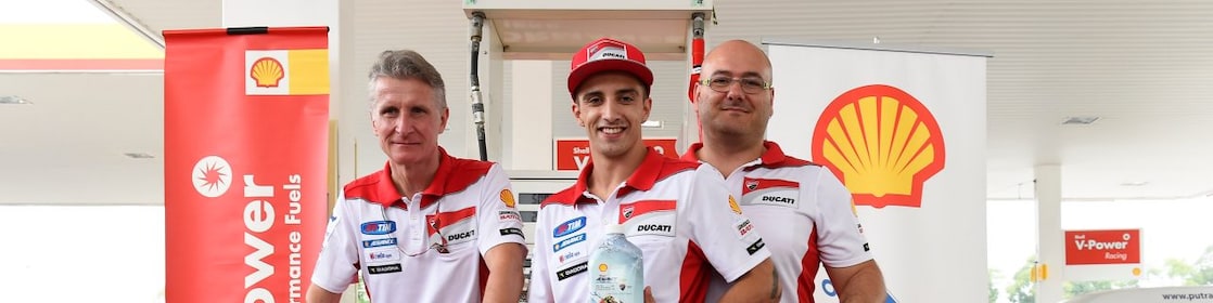 Ducati superbike with seated rider and tech team
