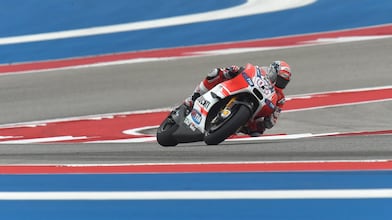 Ducati motorcycle racing around a corner of a racing track