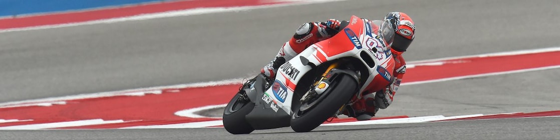 Ducati motorcycle racing around a corner of a racing track