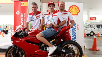 Ducati superbike with seated rider and tech team
