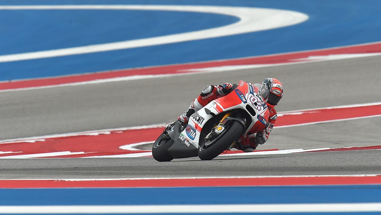 Ducati motorcycle racing around a corner of a racing track