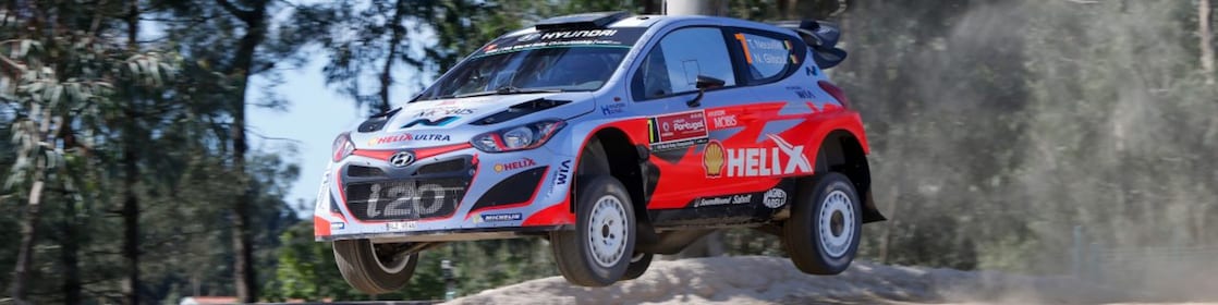 An Hyundai Shell World Rally Team car racing through a forest